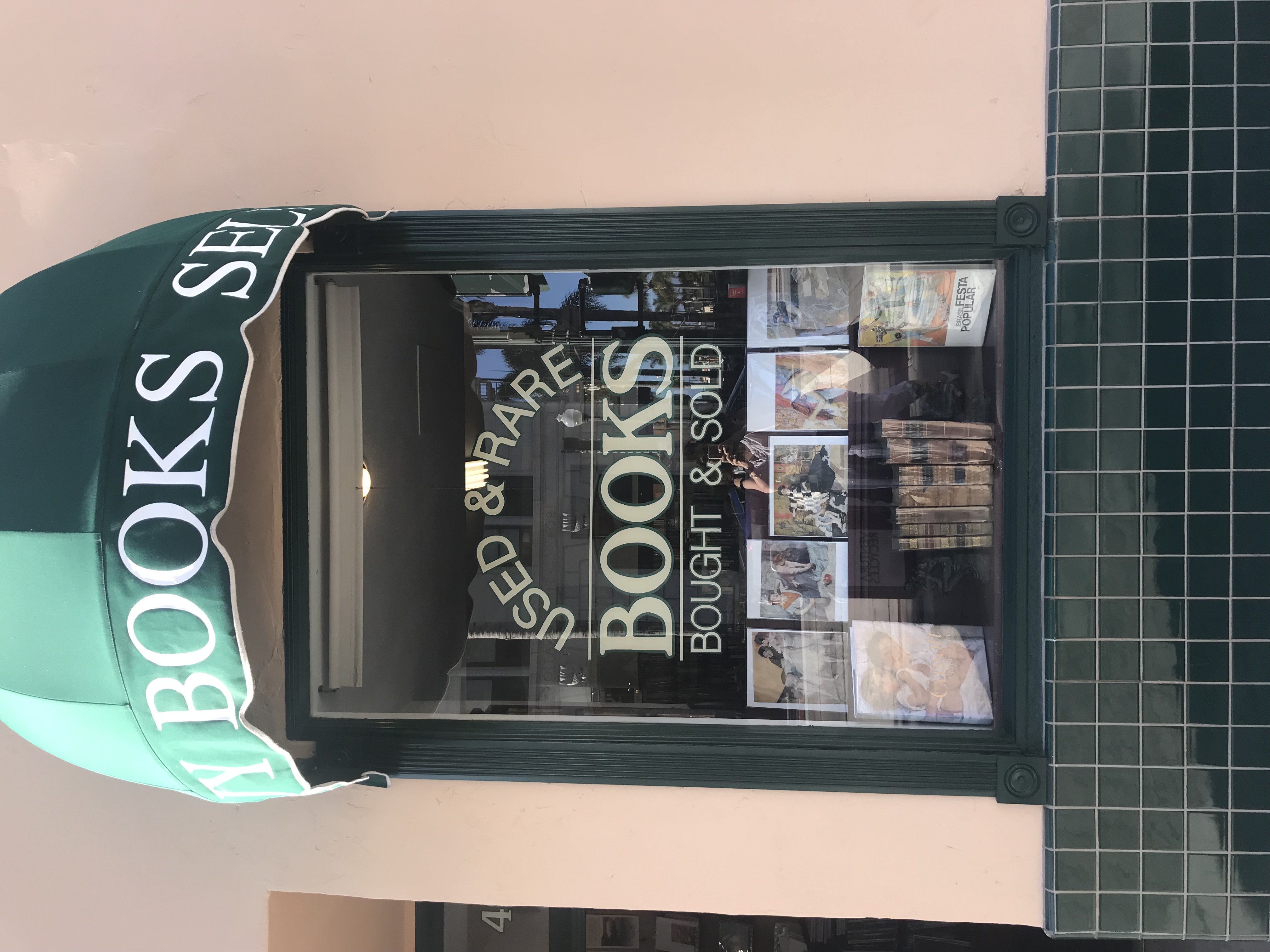 used book store front window promoting used and rare books bought and sold