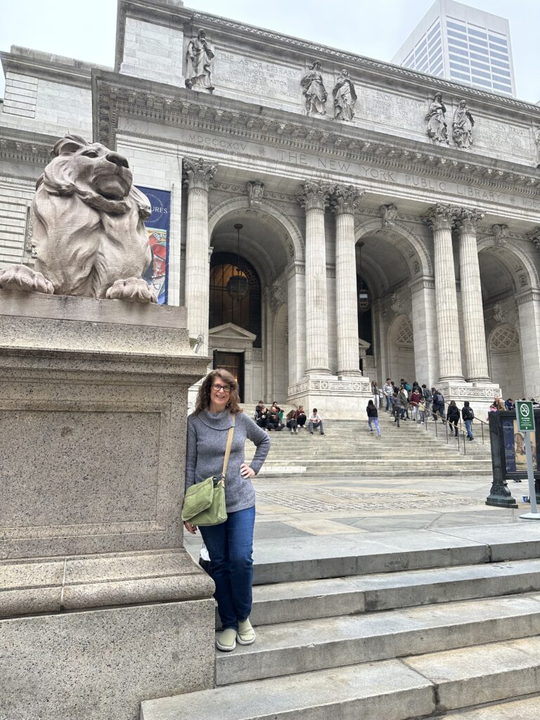 Denise Colby in front of the New York City Library