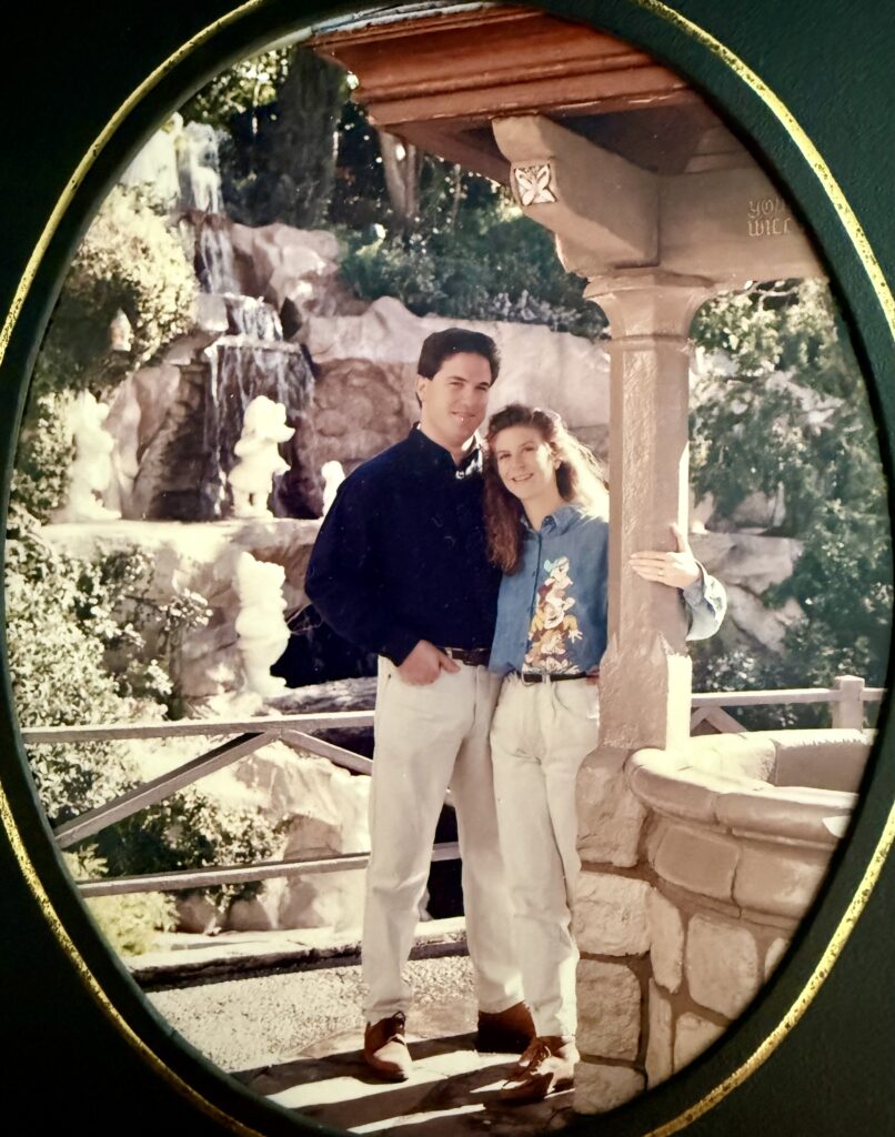 ken and denise engagement pic at the snow white wishing well at Disneyland taken by Turville Photography celebrating thirty years of romance