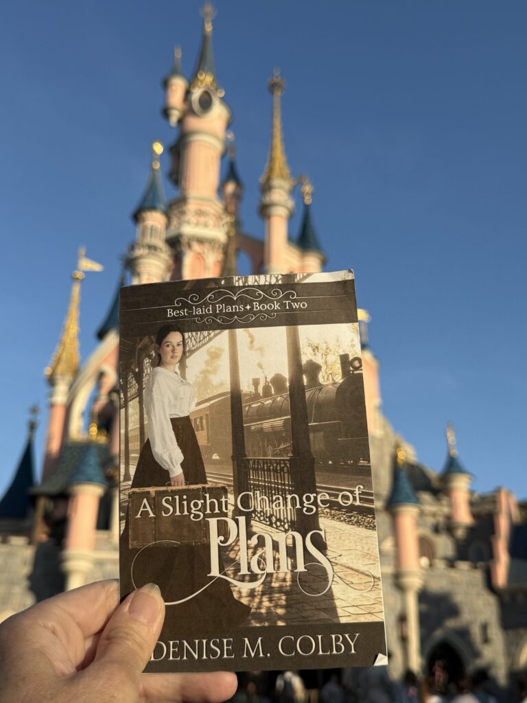 Disneyland Paris sleeping beauty castle in the background with book cover in front for book release