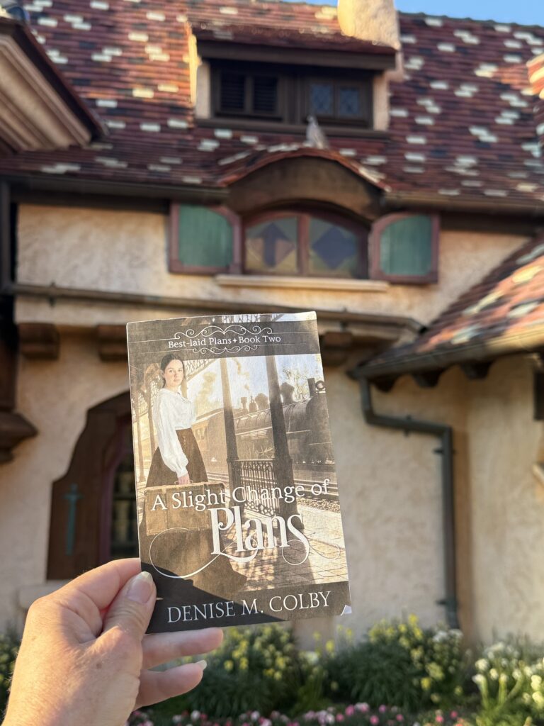 building in the background with a slight change of plans book cover in front for book release photo
